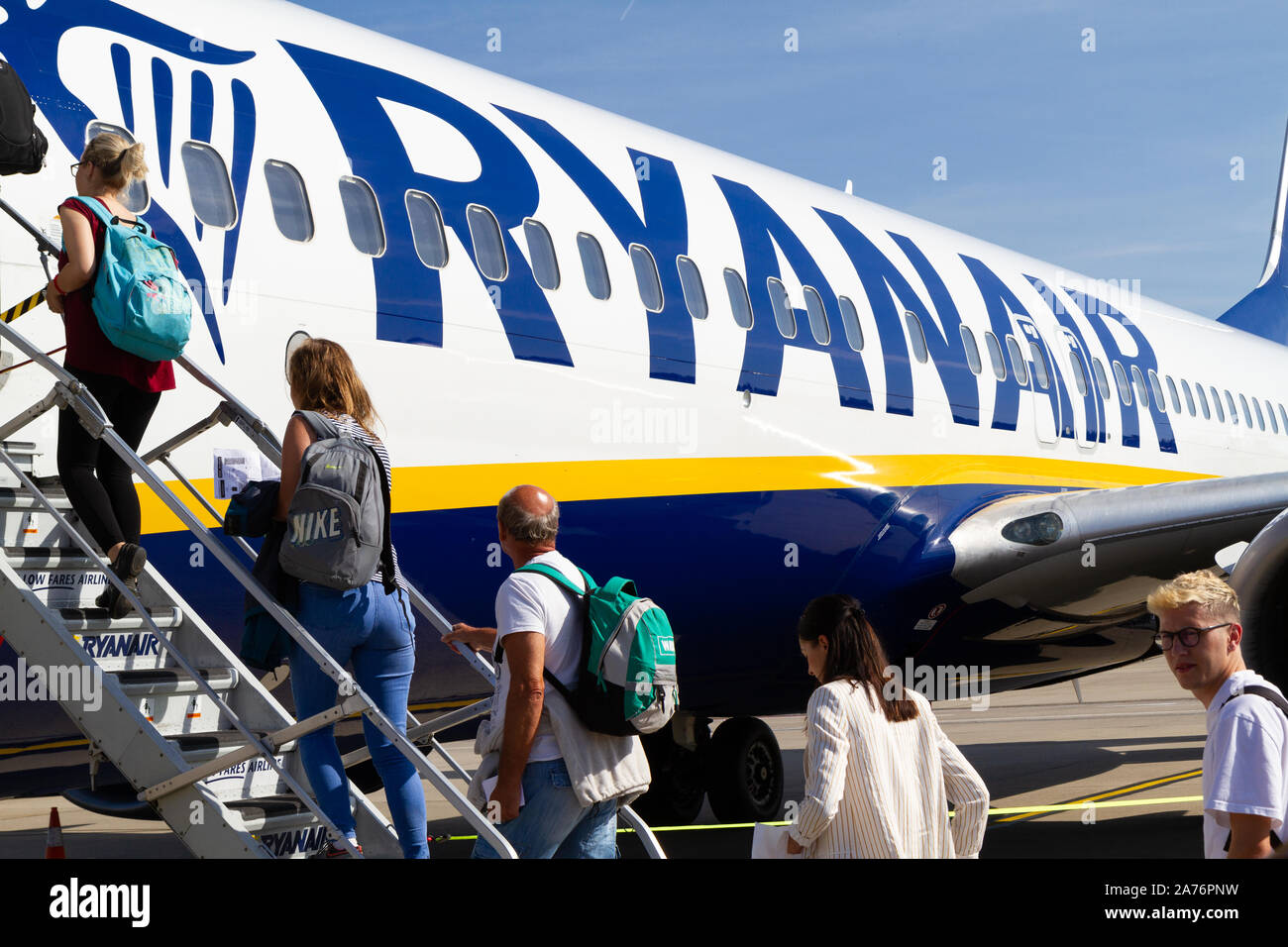 People boarding a Ryanair Boeing 737-800 aircraft at the Charleroi Airport in Belgium. Stock Photo