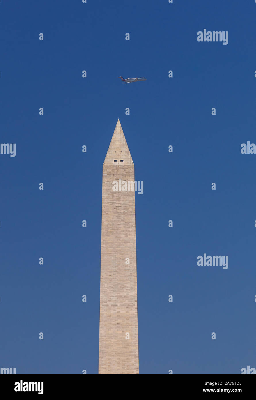 WASHINGTON, DC, USA - Washington Monument, top portion and passing jetliner. Stock Photo