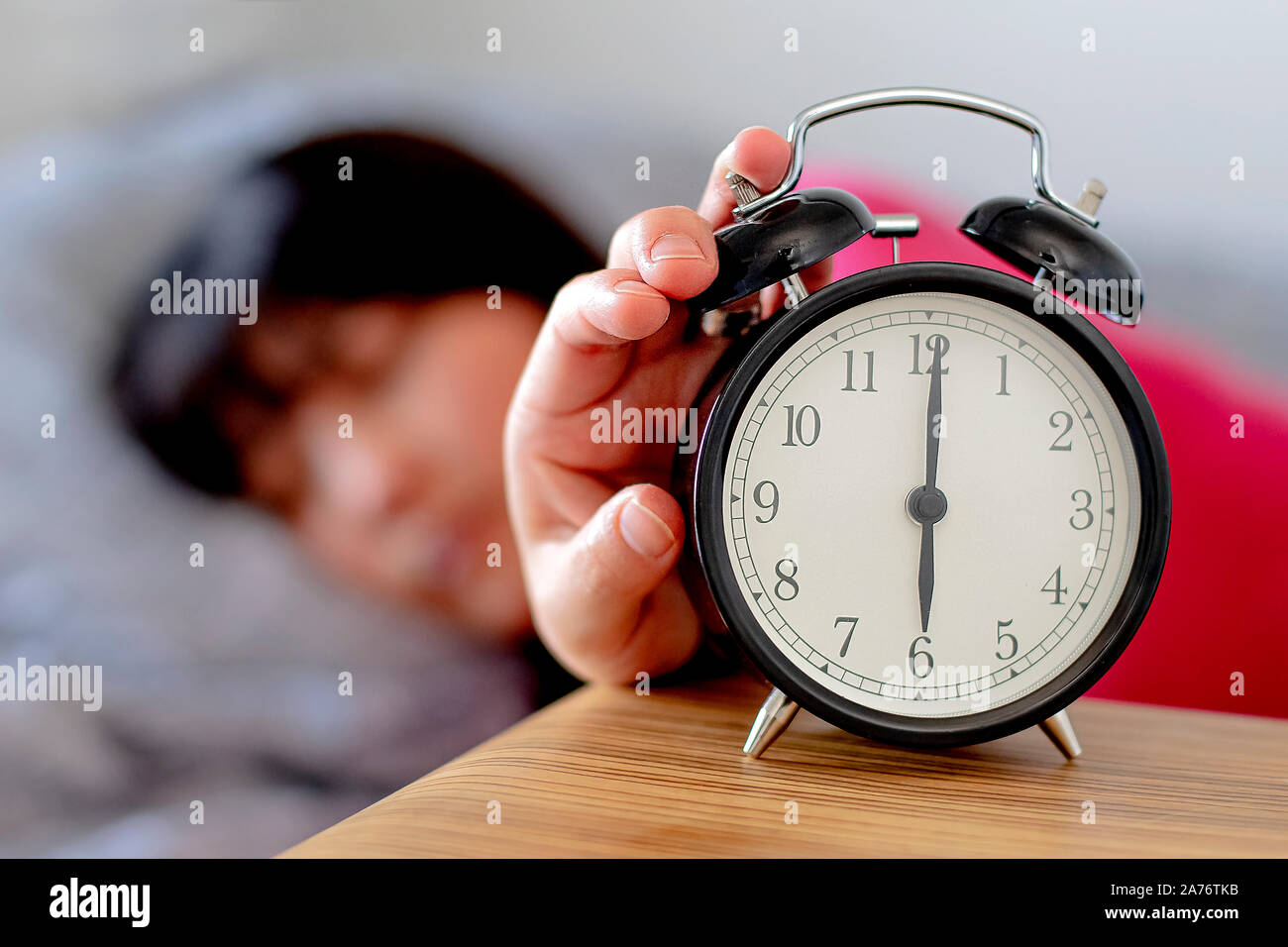 Daylight Saving Time woman waking up Stock Photo
