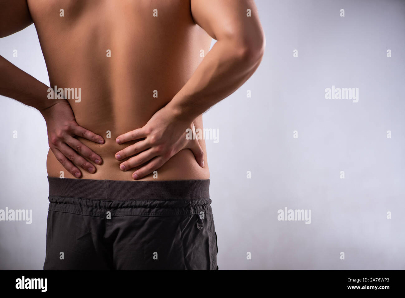 The man suffering from backbain on gray Stock Photo