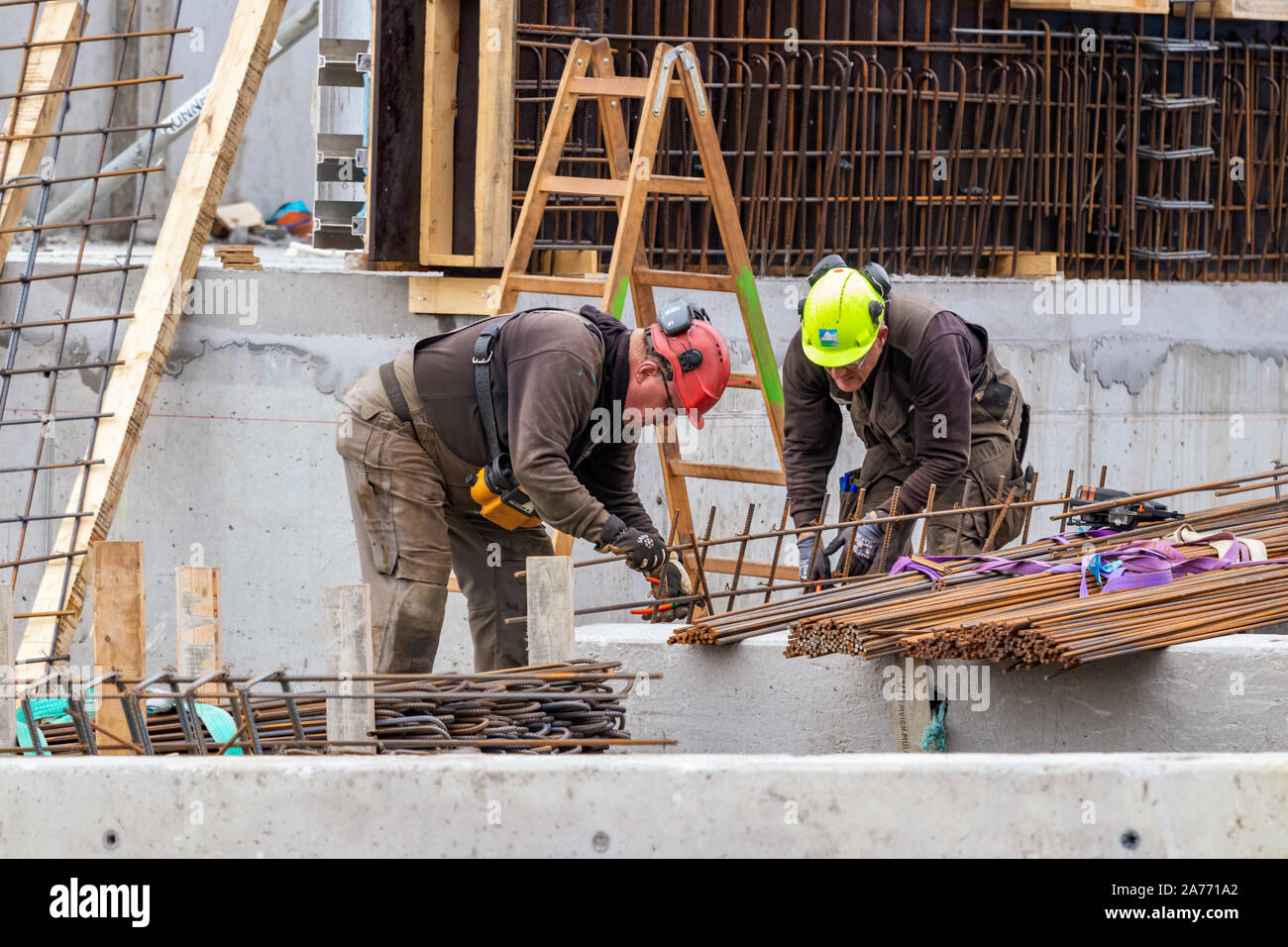 Construction workers bending - wiring concrete steel bars outdoors in Nuuk. Stock Photo