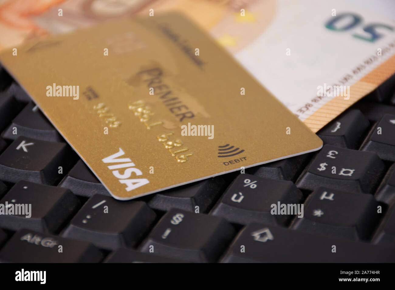 A VISA PREMIER creditcard, placed on a black keyboard, ready to buy online  with this credit card Stock Photo - Alamy