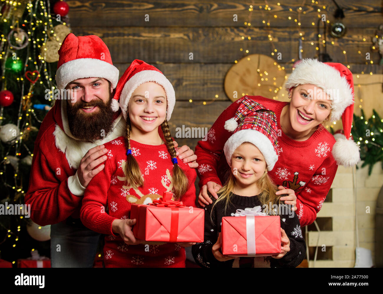 Capturing a happy moment. Happy family celebrate new year. Portrait loving  family. lot of xmas present boxes. merry christmas. Father and mother love  kids. small children and parents in santa hat Stock