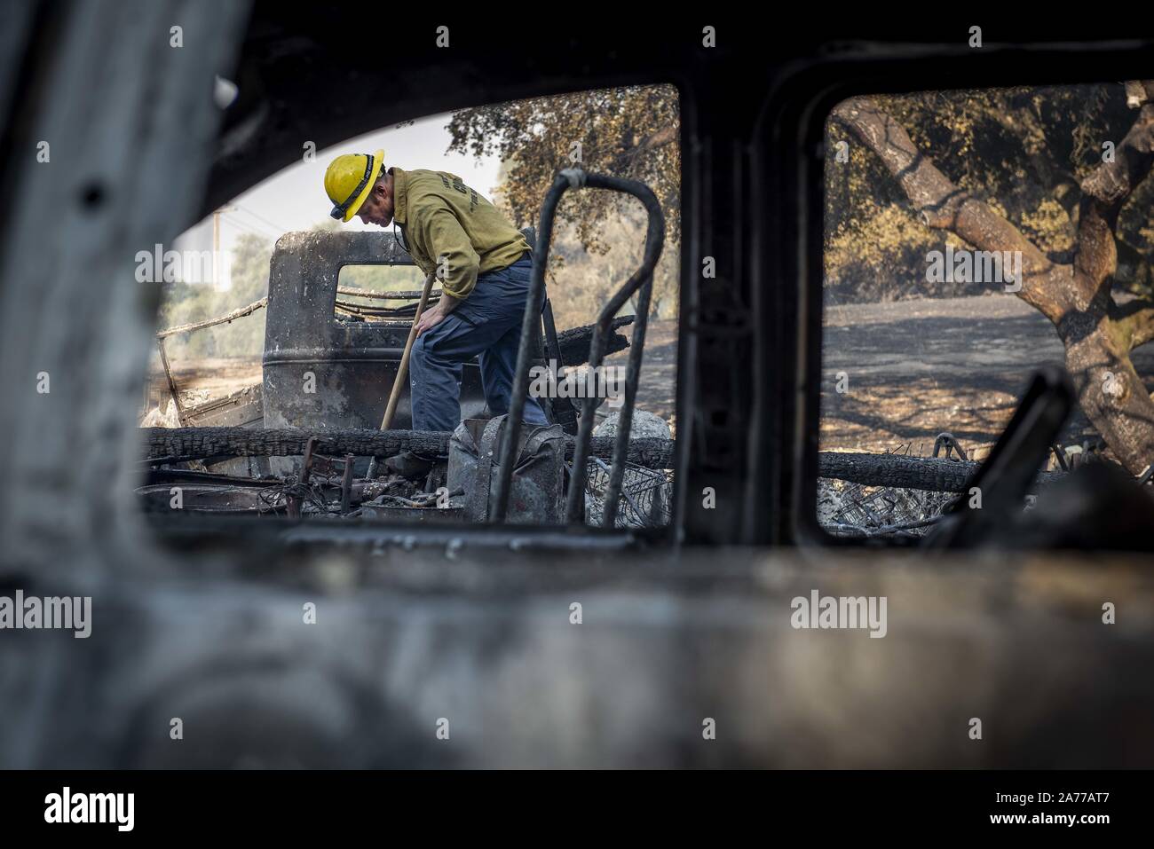 Windsor, California, USA. 29th Oct, 2019. Santa Barbara County Firefighter SHANKAR TILLOTSON, mops up a hot spot of a barn that burned in the Kincade Fire. Credit: Erick Madrid/ZUMA Wire/Alamy Live News Stock Photo