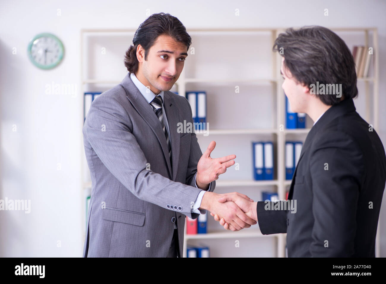 The two young businessmen meeting in the office Stock Photo - Alamy