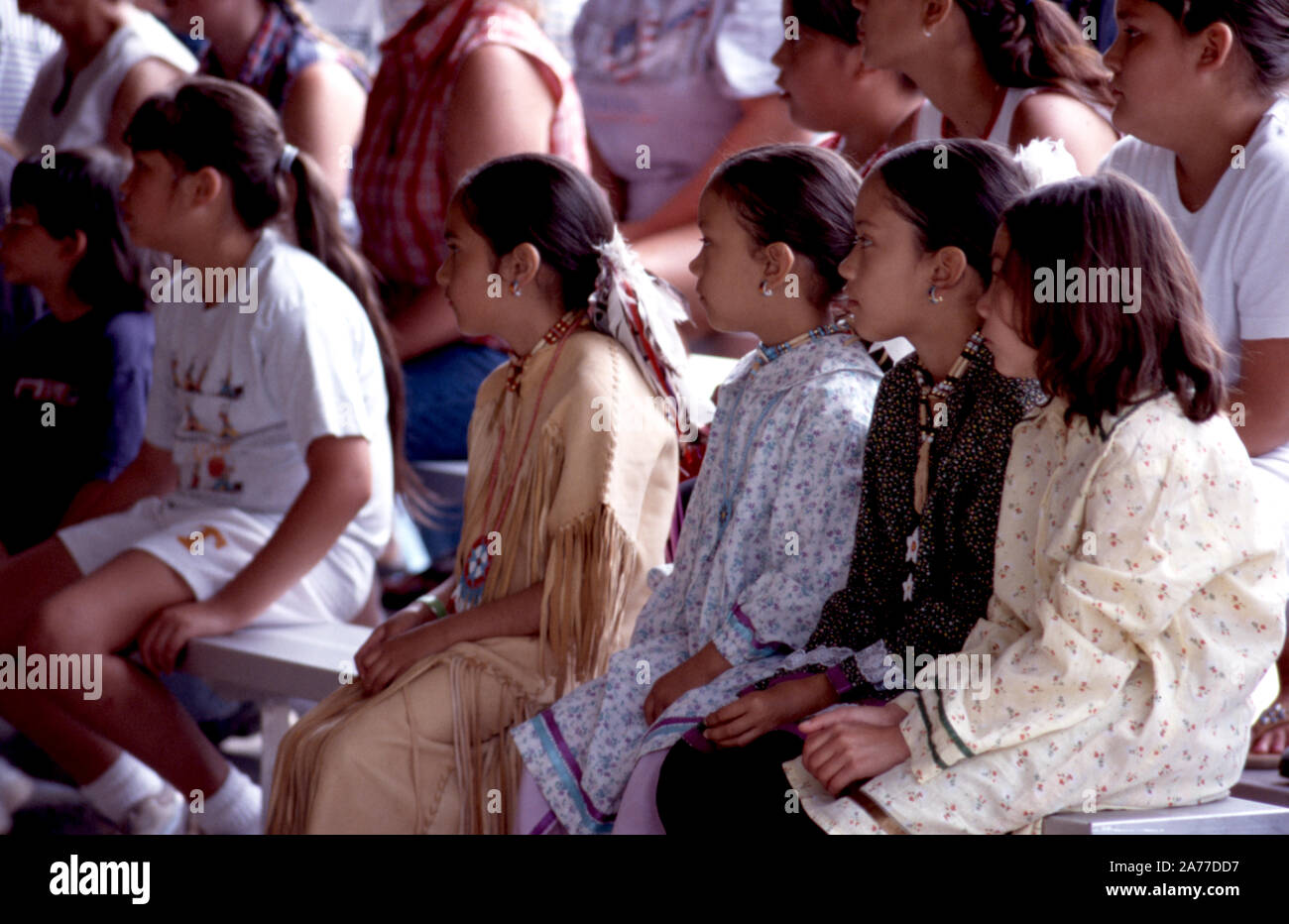 Young Cherokee Indian girls in traditional costume are entertained