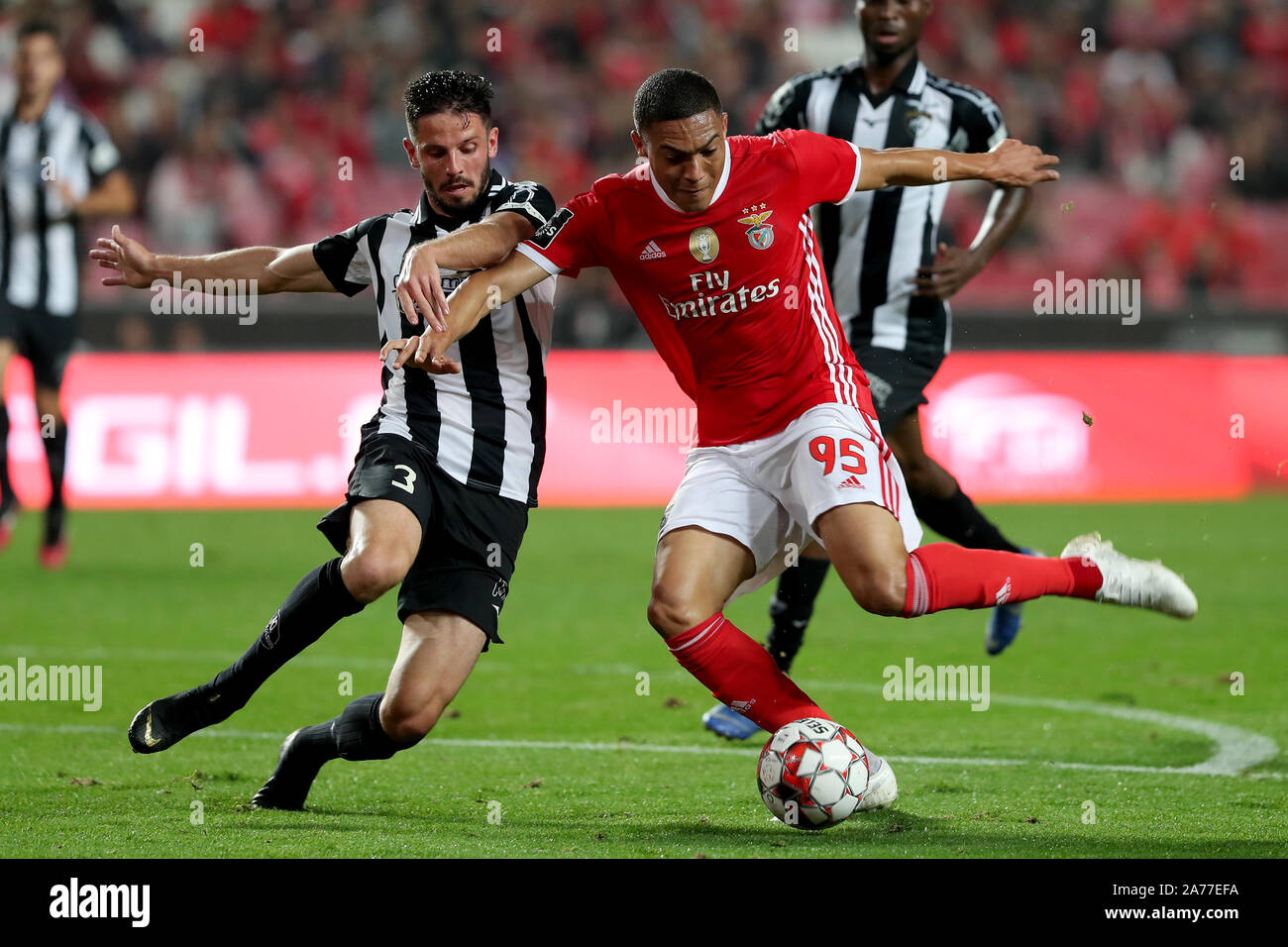 Lisbon, Portugal. 30th Oct, 2019. Carlos Vinicius (R) of Benfica vies with Lucas Possignolo of Portimonense during their Portuguese League football match at the Luz stadium in Lisbon, Portugal, on Oct. 30, 2019. Credit: Pedro Fiuza/Xinhua/Alamy Live News Stock Photo
