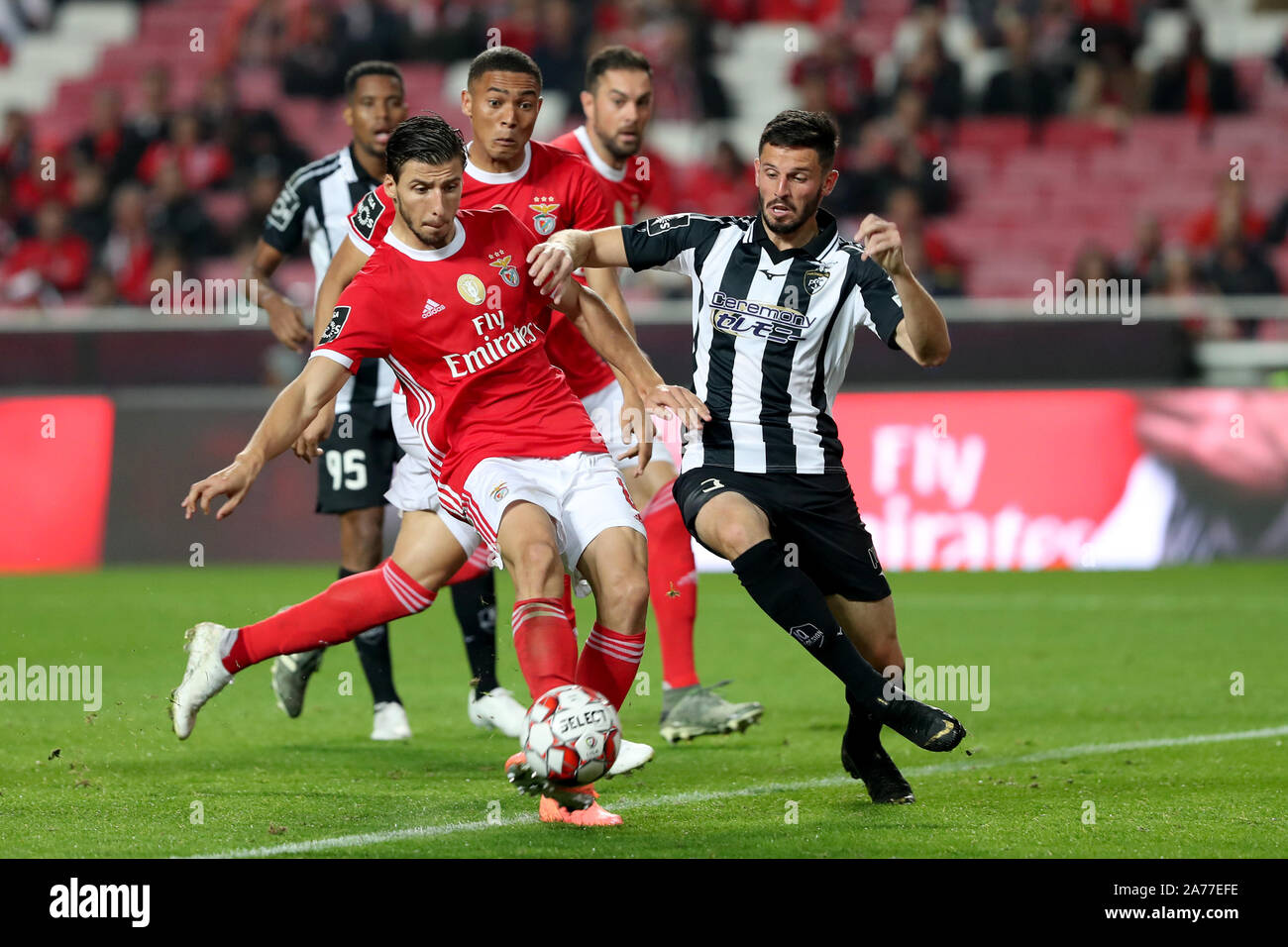 Lisbon, Portugal. 30th Oct, 2019. Ruben Dias (front L) of Benfica shoots and scores during the Portuguese League football match against Portimonense at the Luz stadium in Lisbon, Portugal, on Oct. 30, 2019. Credit: Pedro Fiuza/Xinhua/Alamy Live News Stock Photo