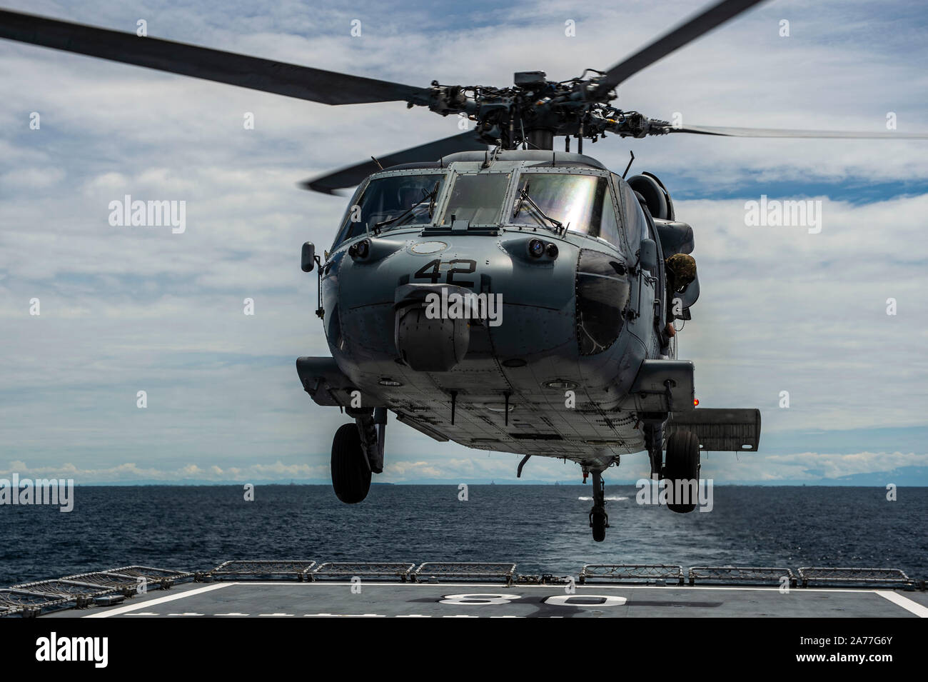 191029-N-FV739-0122  SOUTH CHINA SEA (Oct. 29, 2019) An MH-60S Sea Hawk assigned to the “Wildcards” of Helicopter Sea Combat Squadron (HSC) 23 lands on the flight deck of Royal Brunei Navy offshore patrol vessel KDB Darulaman (DMN 8) during a deck landing exercise in support of Cooperation Afloat Readiness and Training (CARAT) Brunei. This year marks the 25th iteration of CARAT, a multinational exercise designed to enhance U.S. and partner navies' abilities to operate together in response to traditional and non-traditional maritime security challenges in the Indo-Pacific region. (U.S. Navy pho Stock Photo