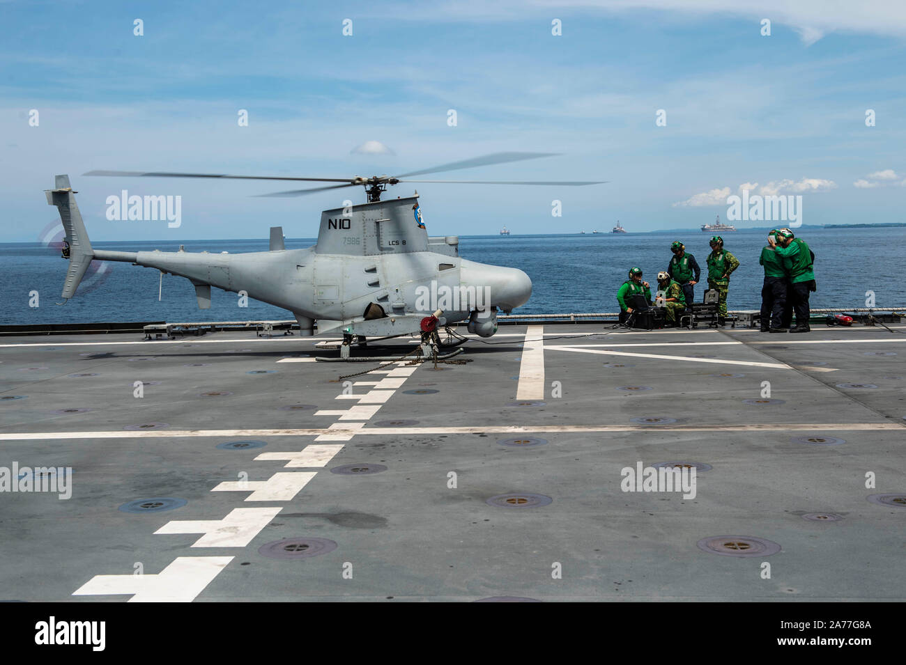 191030-N-FV739-0876  SOUTH CHINA SEA (Oct. 30, 2019) U.S. Navy Sailors demonstrate unmanned aerial vehicle MQ-8B Firescout capabilities and configurations with Royal Brunei Armed Forces aboard the Independence-variant littoral combat ship USS Montgomery (LCS 8) during Cooperation Afloat Readiness and Training (CARAT) Brunei. This year marks the 25th iteration of CARAT, a multinational exercise designed to enhance U.S. and partner navies' abilities to operate together in response to traditional and non-traditional maritime security challenges in the Indo-Pacific region. (U.S. Navy photo by Mass Stock Photo