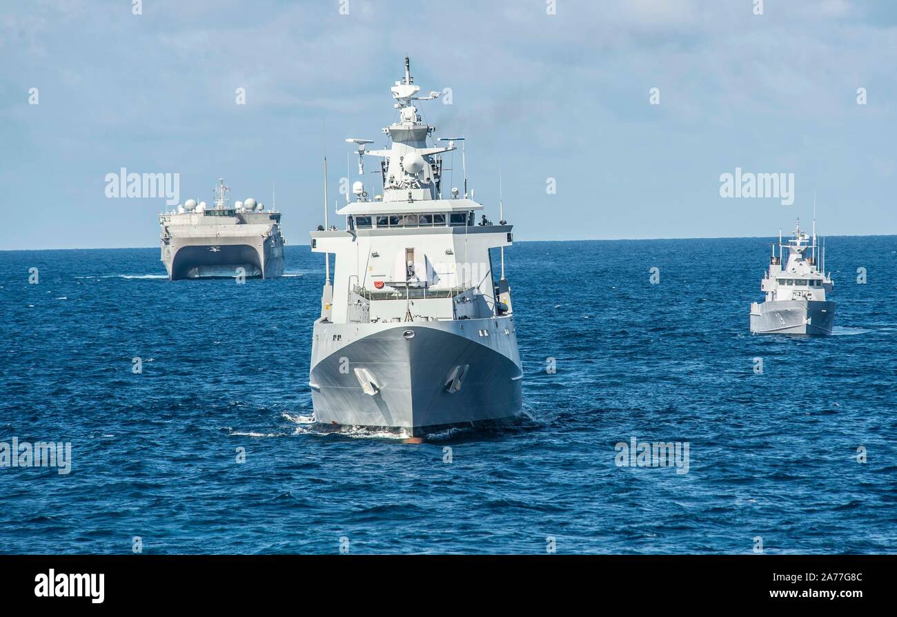 191030-N-FV739-0745  SOUTH CHINA SEA (Oct. 30, 2019) The Royal Brunei Navy offshore patrol vessel KDB Darulaman (DMN 8), inshore patrol vessel KDB Syafaat (SYA 19) and Spearhead-class expeditionary fast transport USNS Millinocket (T-EPF 3), transit in formation for a visit board search and seizure (VBSS) exercise in support of Cooperation Afloat Readiness and Training (CARAT) Brunei. This year marks the 25th iteration of CARAT, a multinational exercise designed to enhance U.S. and partner navies' abilities to operate together in response to traditional and non-traditional maritime security cha Stock Photo