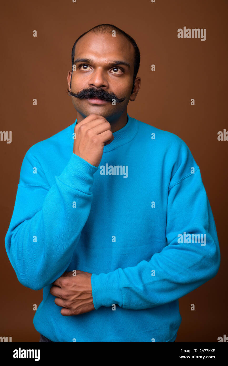 Portrait of Indian man with mustache wearing blue sweater Stock Photo Alamy