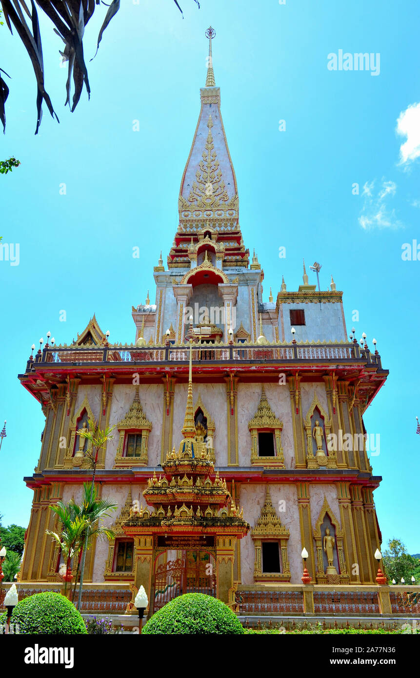 A view of the chedi betwen two palm trees at Chalong Temple Phuket Thailand Stock Photo