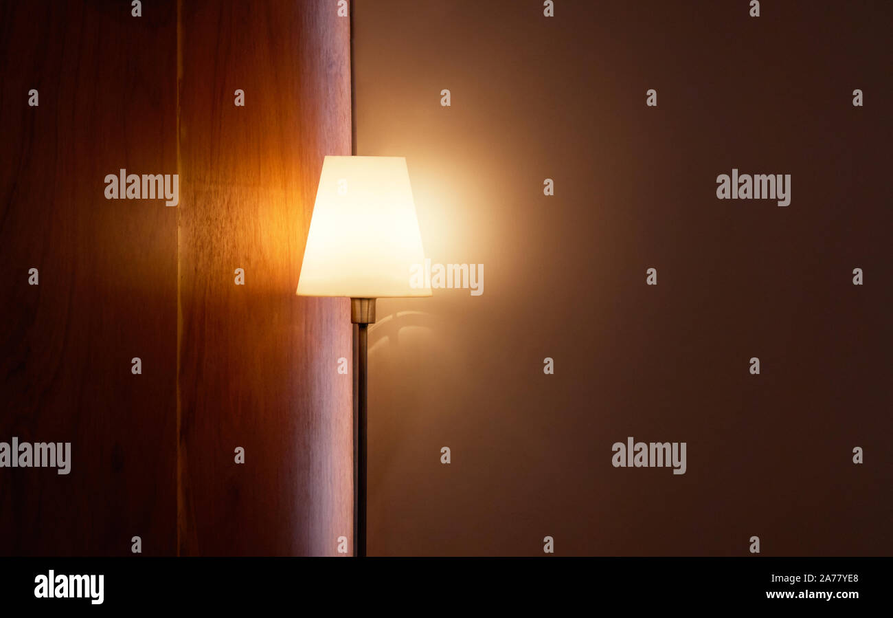 Floor lamp illuminating, in the corner of living room Stock Photo