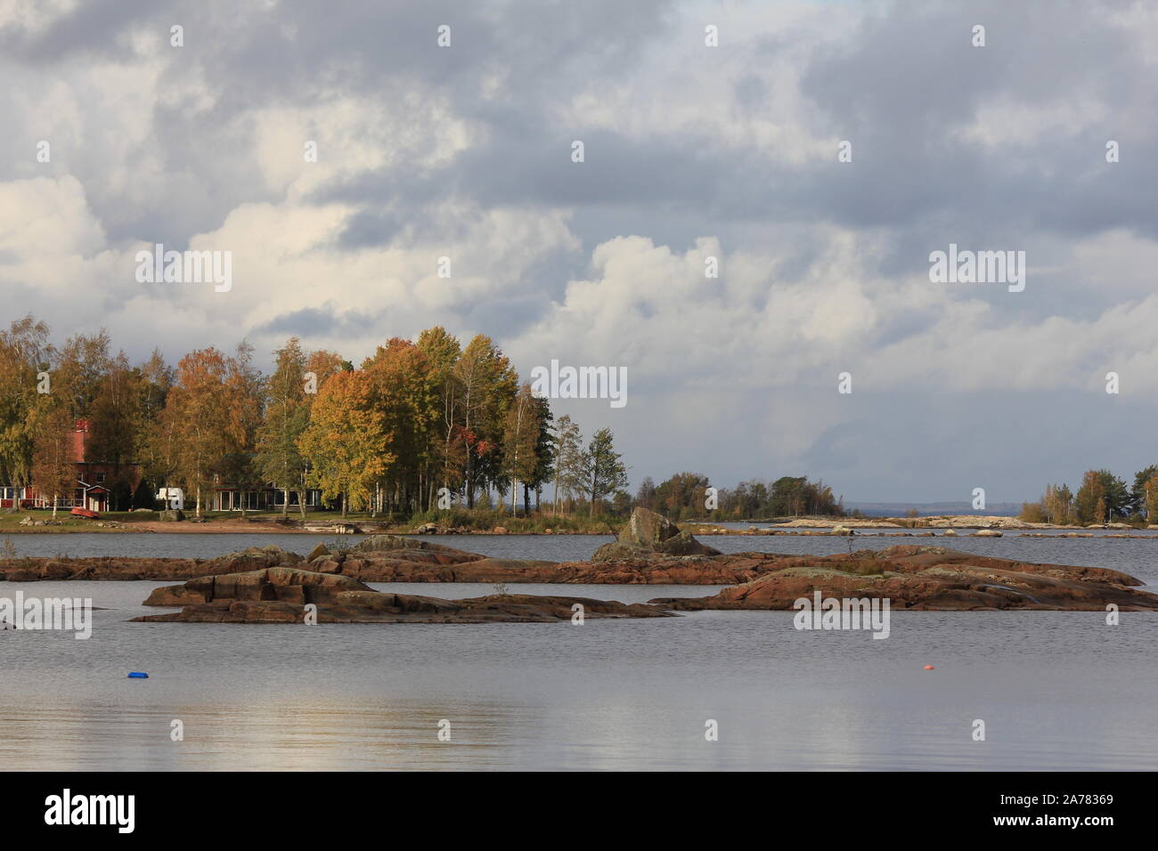 Rock formations and colorful trees at the shore of Lake Vanern, Sweden. Stock Photo