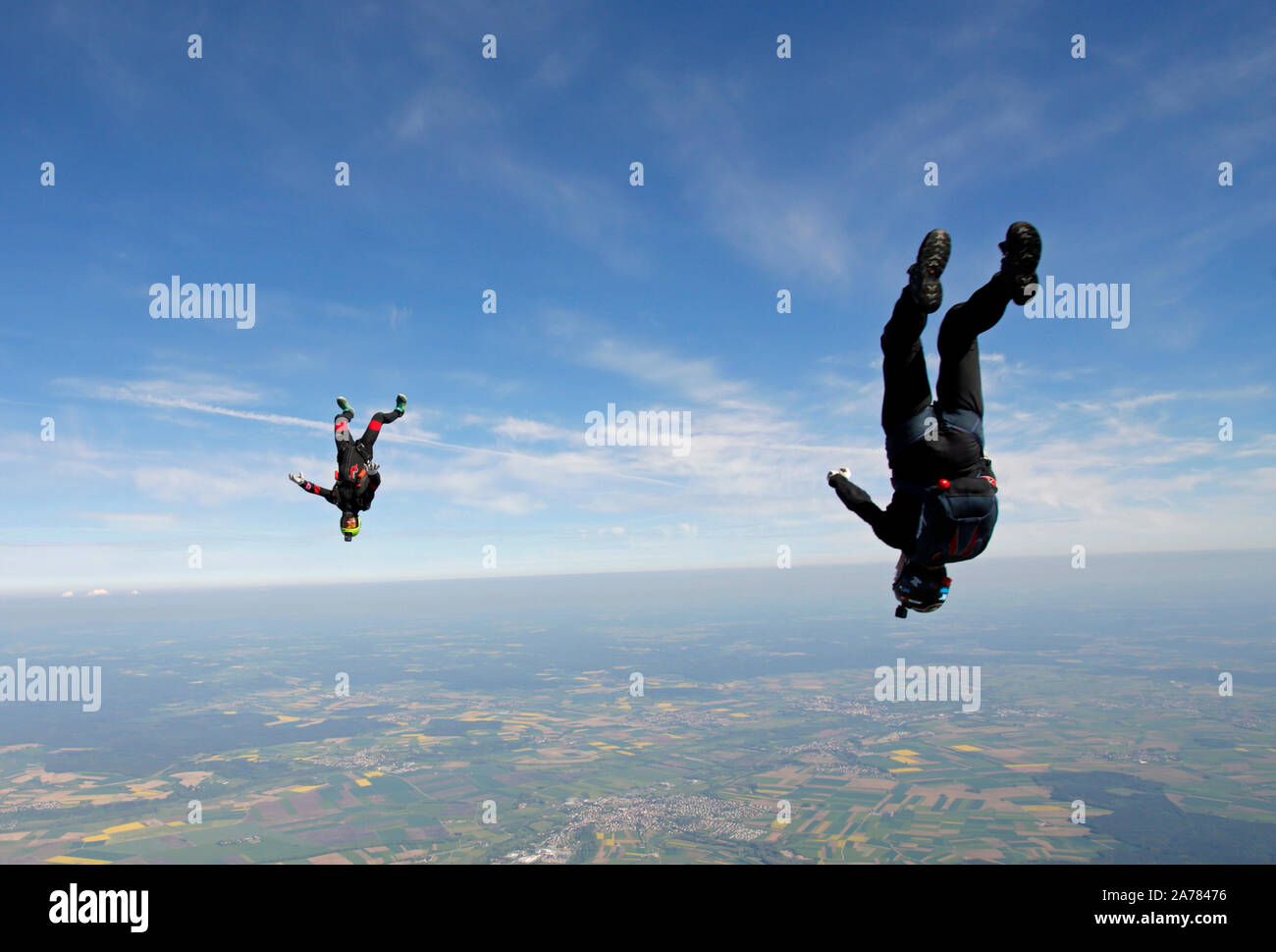 This skydiver head down team is training together the inface tracking around each other. It is fun for both divers and soon they will hold grips. Stock Photo
