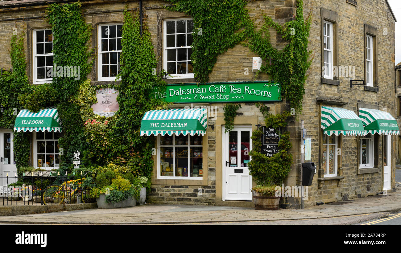 Exterior of quaint inviting sunlit ivy-clad Dalesman Café Tearoom & Sweet Emporium (name over entrance door) - Gargrave, North Yorkshire, England, UK. Stock Photo