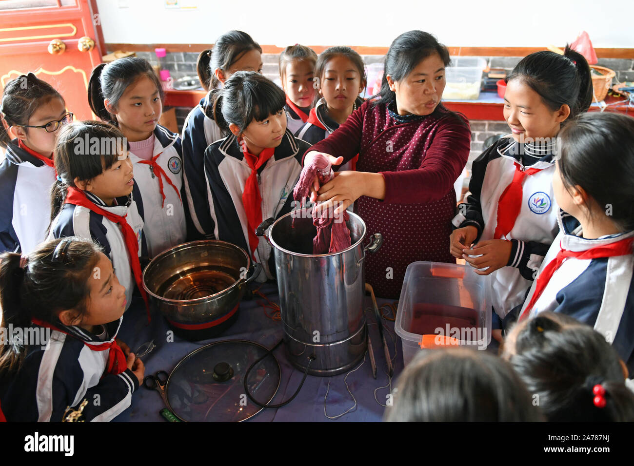 Jinan, China's Shandong Province. 30th Oct, 2019. Pupils of Xixian primary school experience the art of vegetation dyeing at Lubei intangible cultural heritage experiencing center in Wudi County, east China's Shandong Province, Oct. 30, 2019. The experiencing center provides a variety of intangible cultural heritage experiencing programs, including the arts of rubbing, ceramics, tie dyeing, paper-making and movable-type printing, aiming to promote traditional Chinese culture through immersive experience. Credit: Zhu Zheng/Xinhua/Alamy Live News Stock Photo