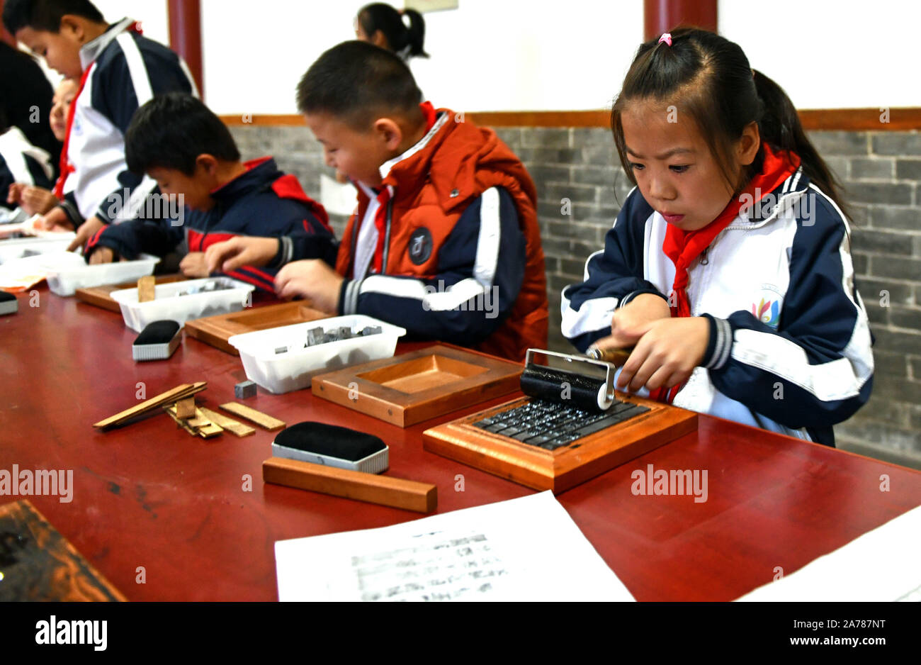 Jinan, China's Shandong Province. 30th Oct, 2019. Pupils of Xixian primary school experience movable-type printing at Lubei intangible cultural heritage experiencing center in Wudi County, east China's Shandong Province, Oct. 30, 2019. The experiencing center provides a variety of intangible cultural heritage experiencing programs, including the arts of rubbing, ceramics, tie dyeing, paper-making and movable-type printing, aiming to promote traditional Chinese culture through immersive experience. Credit: Zhu Zheng/Xinhua/Alamy Live News Stock Photo