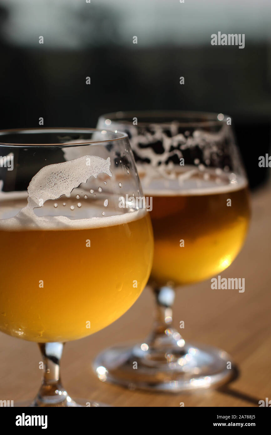 Two snifter glass with beer on the sun on the table Stock Photo Alamy