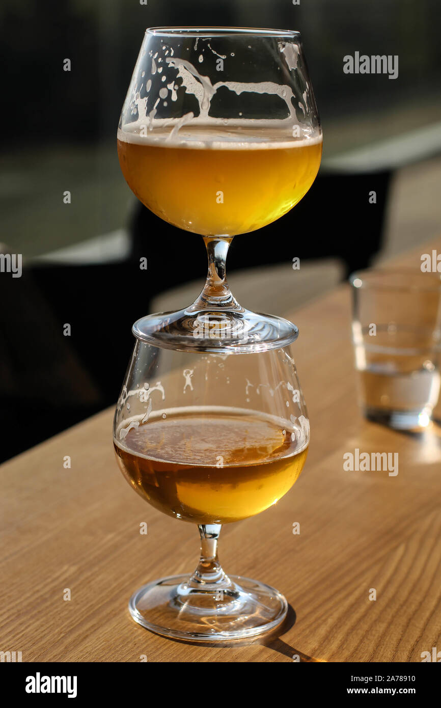 Two snifter glass with beer one on top of the other Stock Photo Alamy