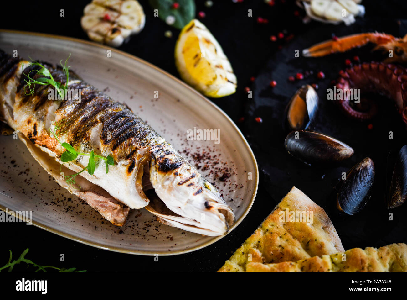 delicious grilled fish with lemon, salt & pepper Stock Photo