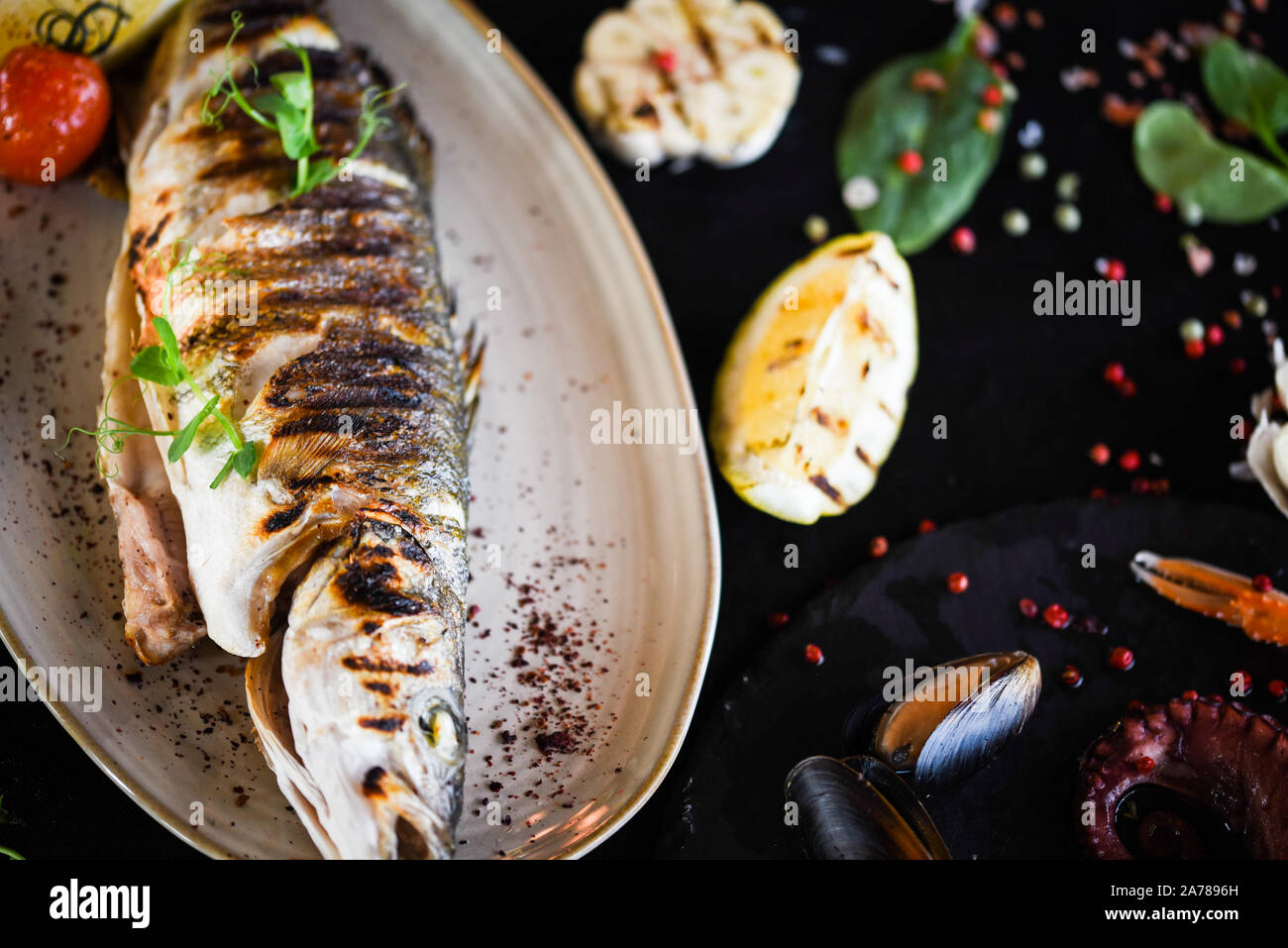 delicious grilled fish with lemon, salt & pepper Stock Photo