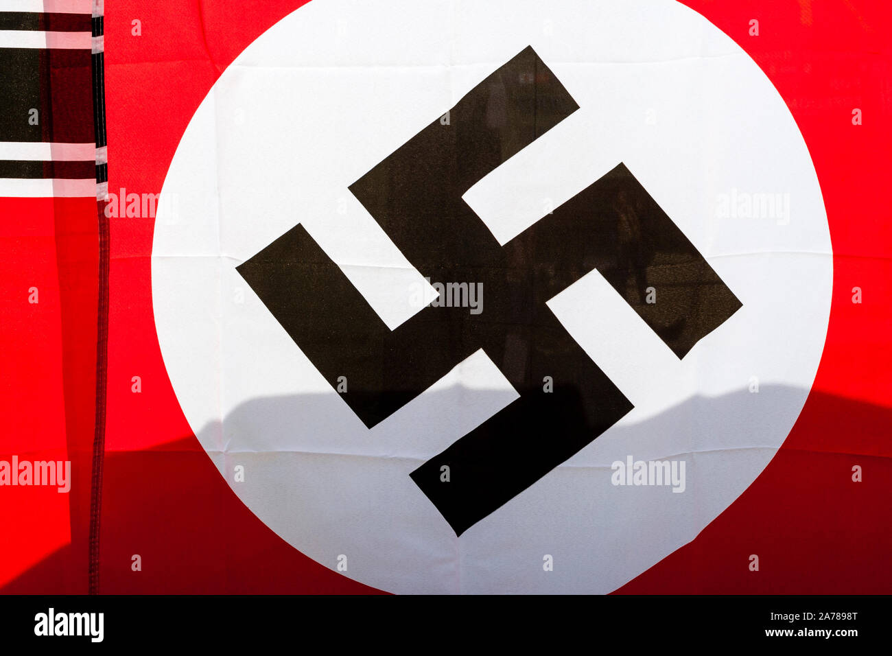 Close up of second World war German Nazi flag. Black Swastika on white ball surrounded by red. Stock Photo