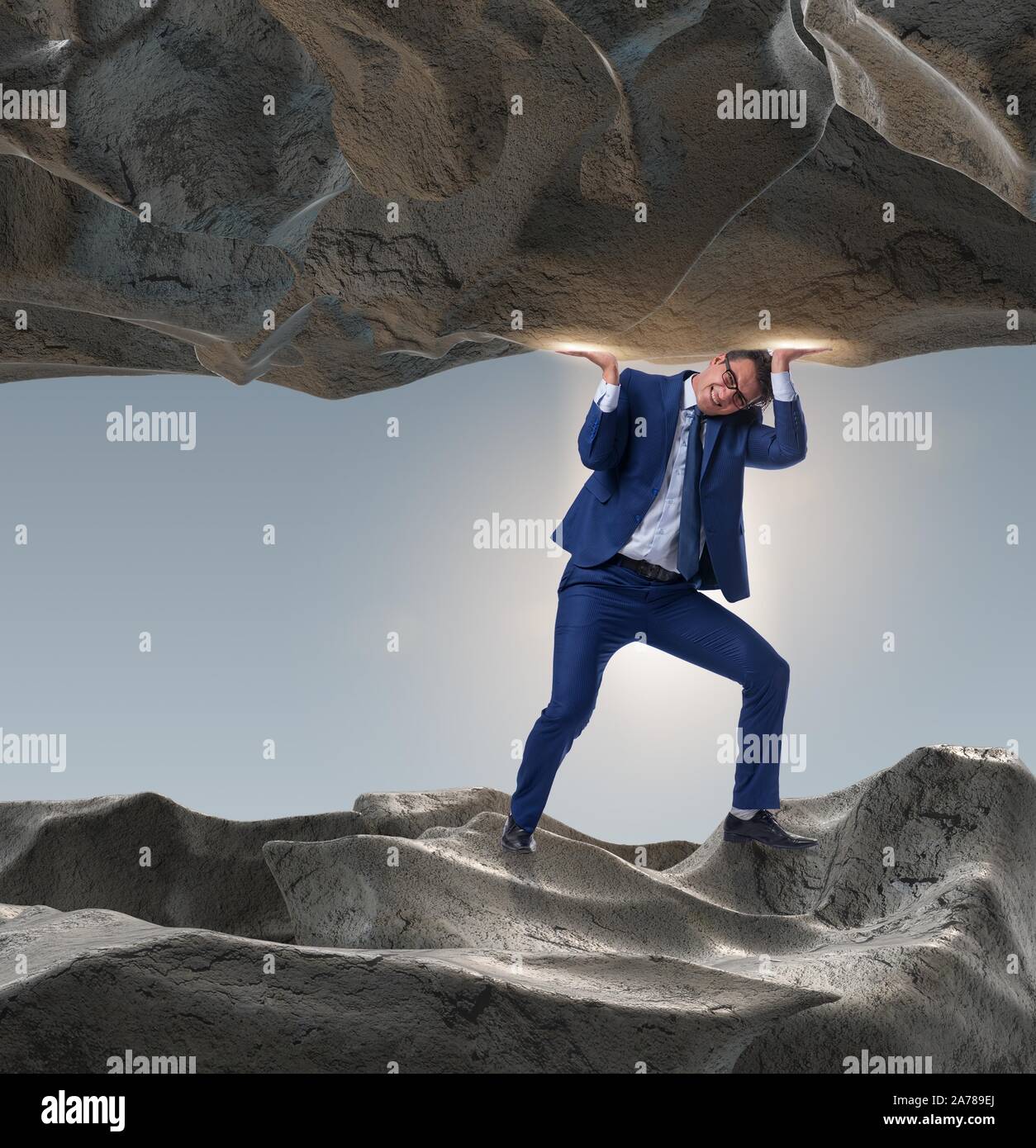 The businessman supporting stone under pressure Stock Photo - Alamy