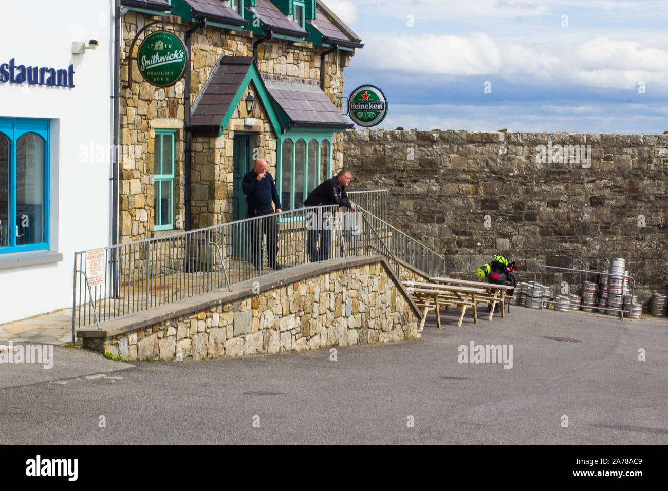 23 August 2019 Customers having a smoke outside a small pub in the harbour village of Mullaghmore County Sligo Ireland Stock Photo