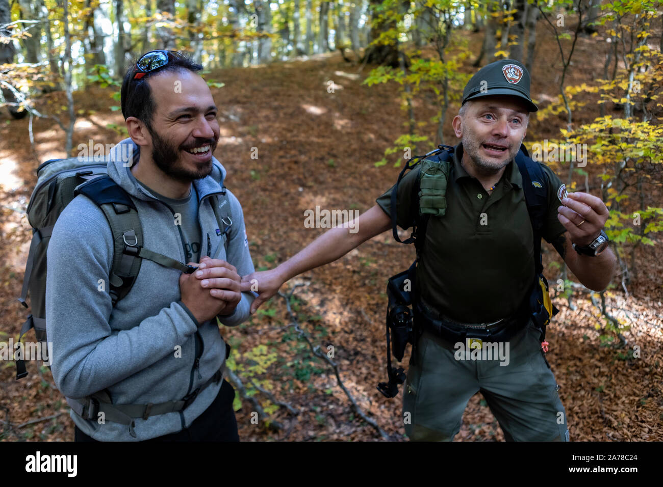 Hiker and park ranger in the forests of Abruzzo National Park, home to ...