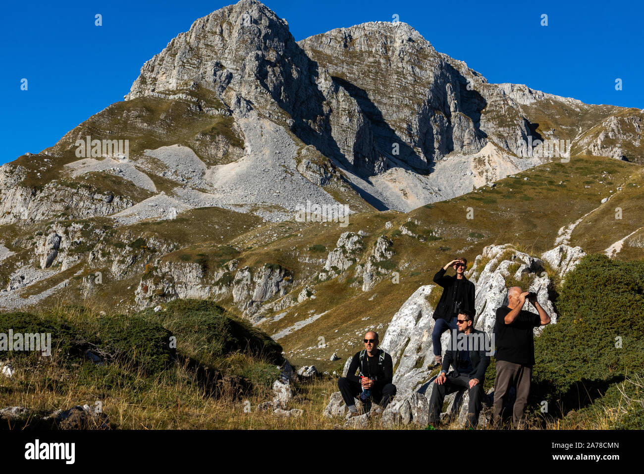 Hikers on the Campo Imperatore Plain with Gran Sasso, Abruzzo National Park, Italy Stock Photo