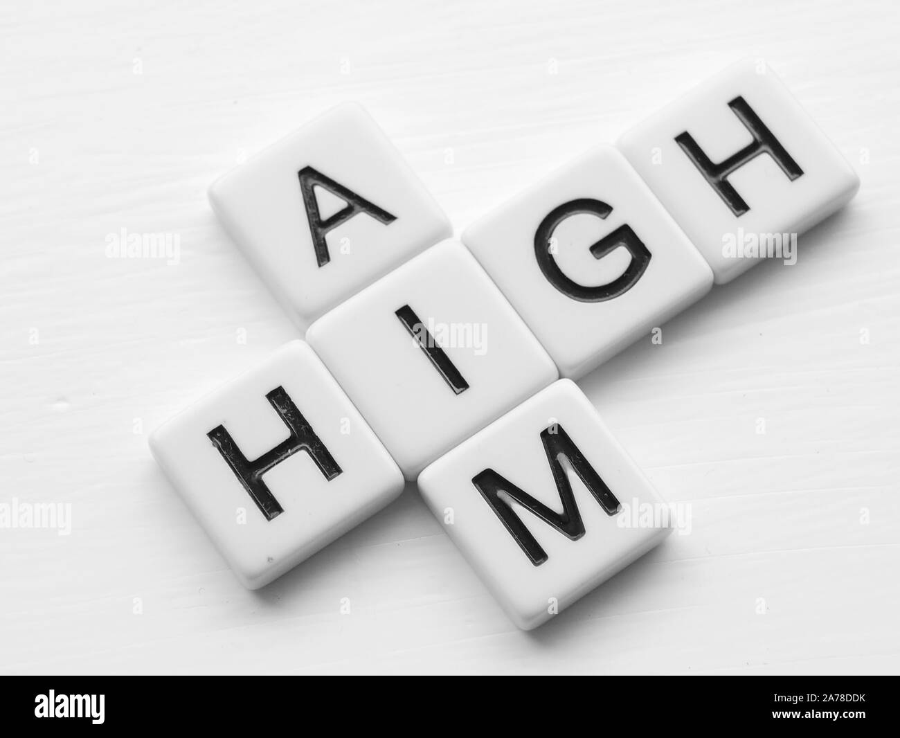 Words aim and high in crossword style in black lettering on white tiles Stock Photo