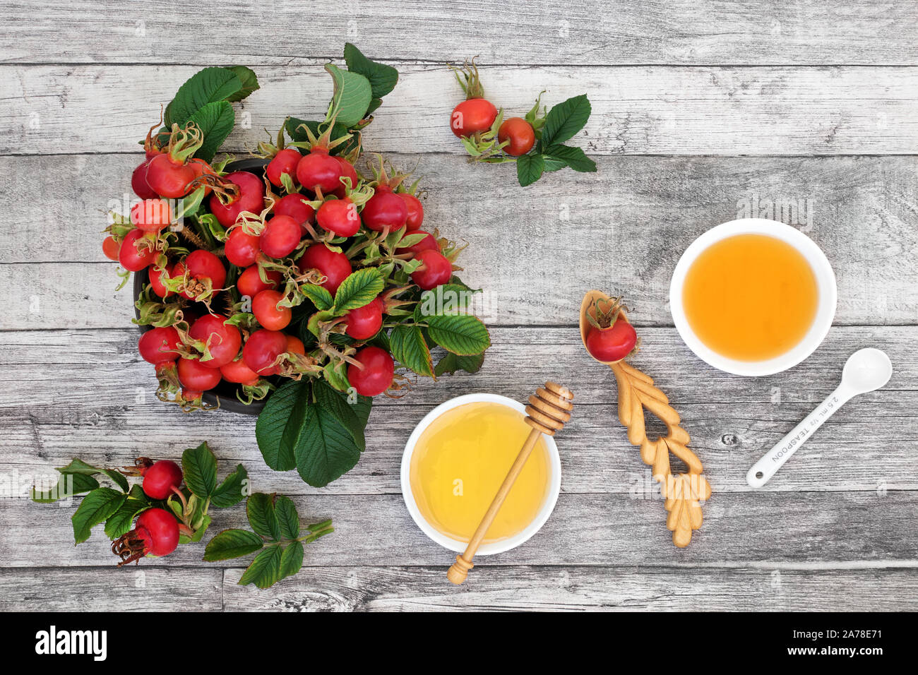 Rosehip berry fruit health food used in herbal medicine for cold and flu remedy drink with honey and apple cider vinegar. High in antioxidants. Stock Photo