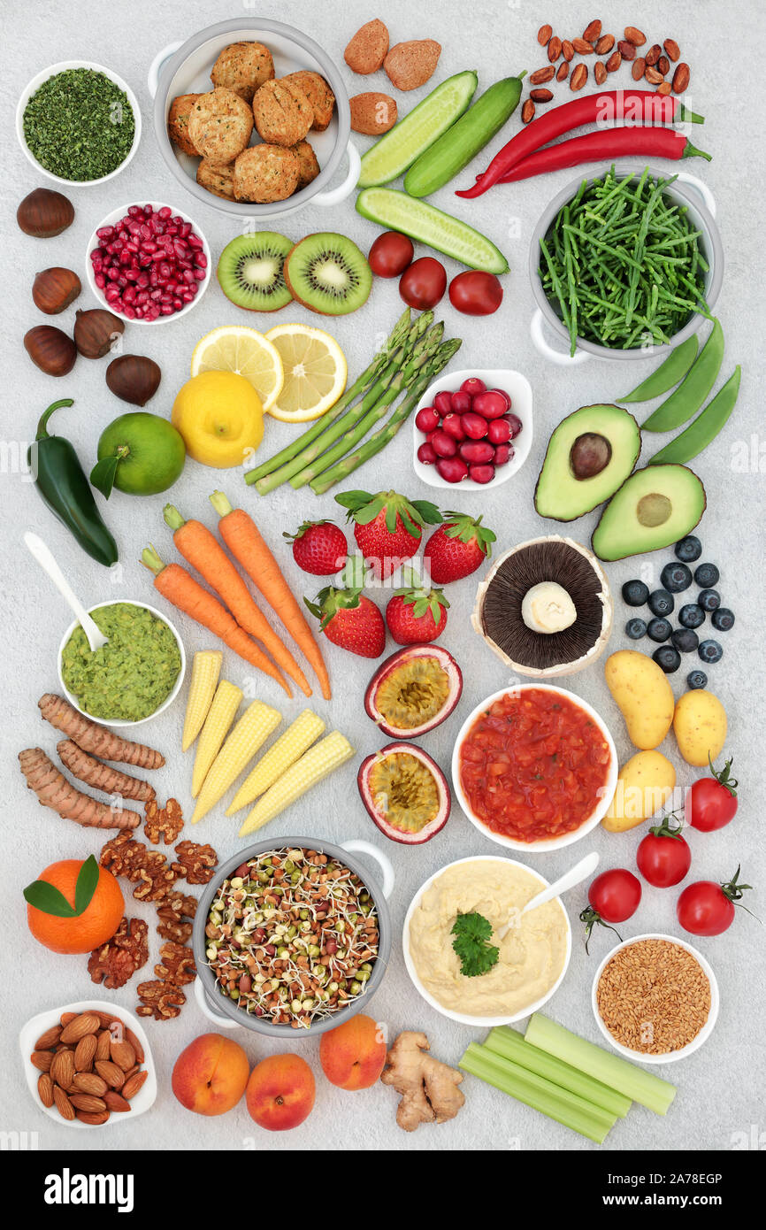 Healthy vegan super food concept with fruit, vegetables, seeds, nuts, spice, dips & falafel meat