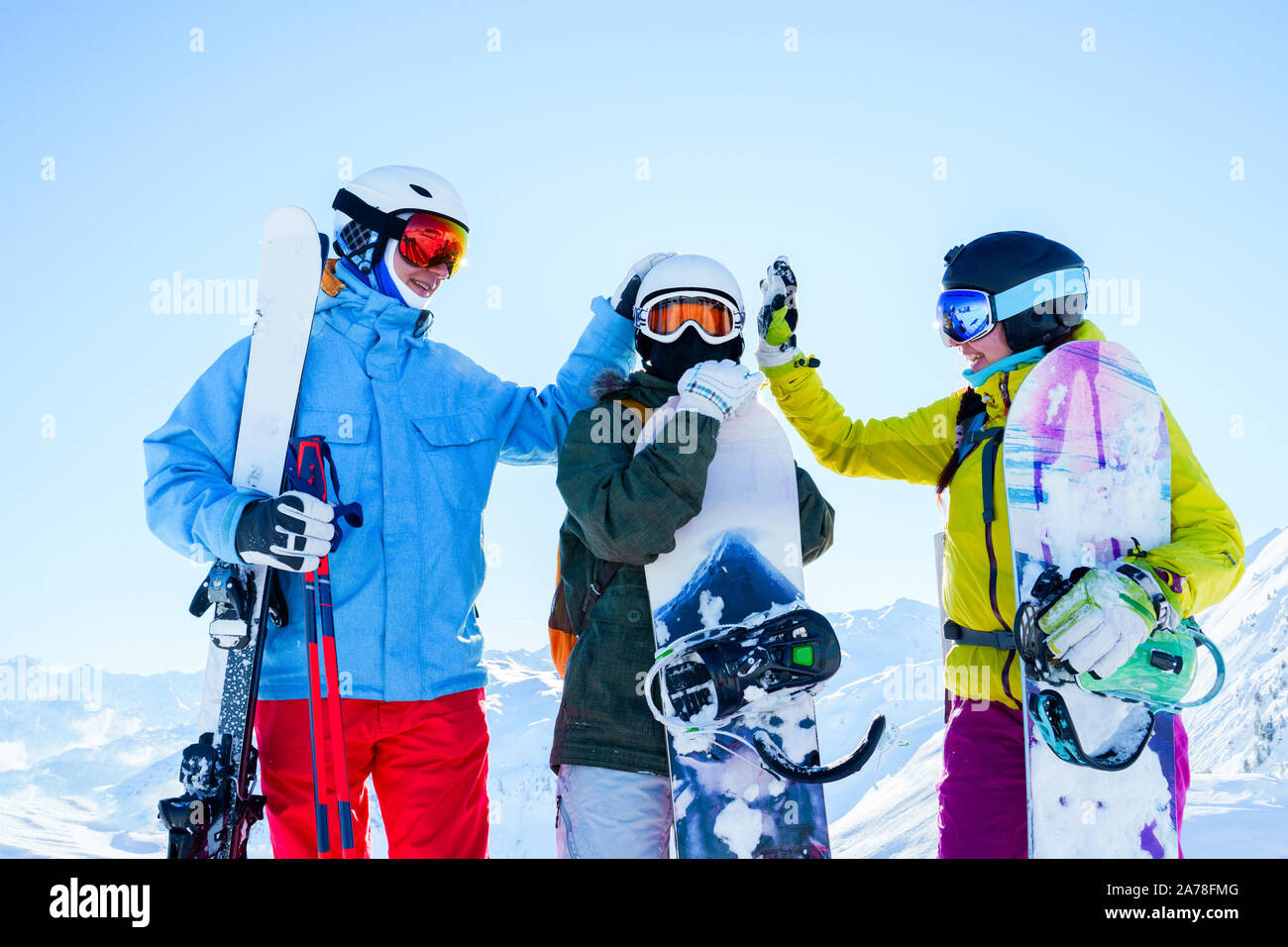 Image of three athletes in helmet doing handshake at snow resort on ...