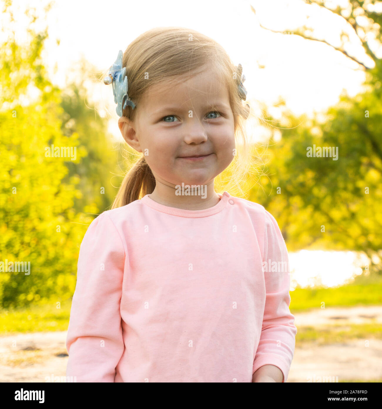 Sweet adorable little kid girl is smiling Stock Photo