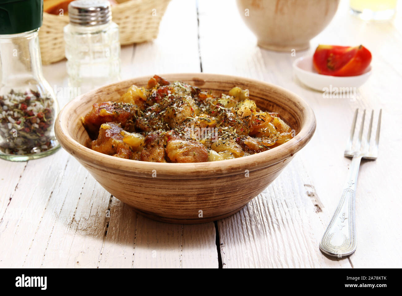 Braising Italian meat with dry herbs and onions Stock Photo Alamy