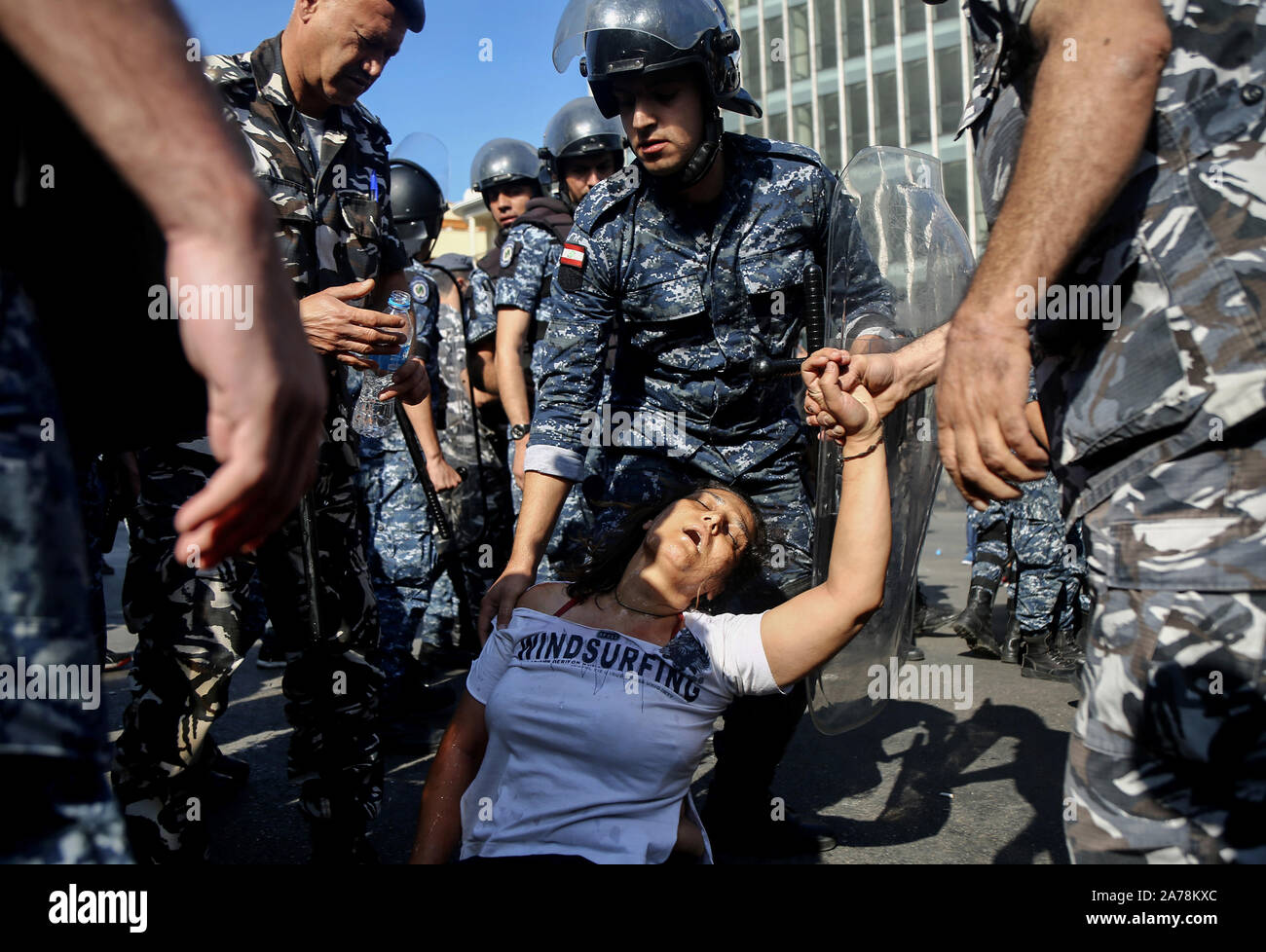 Beirut, Lebanon. 31st Oct, 2019. A police soldier helps a protestor who fainted while evacuating demonstrators after blocking a vital road. Credit: Marwan Naamani/dpa/Alamy Live News Stock Photo