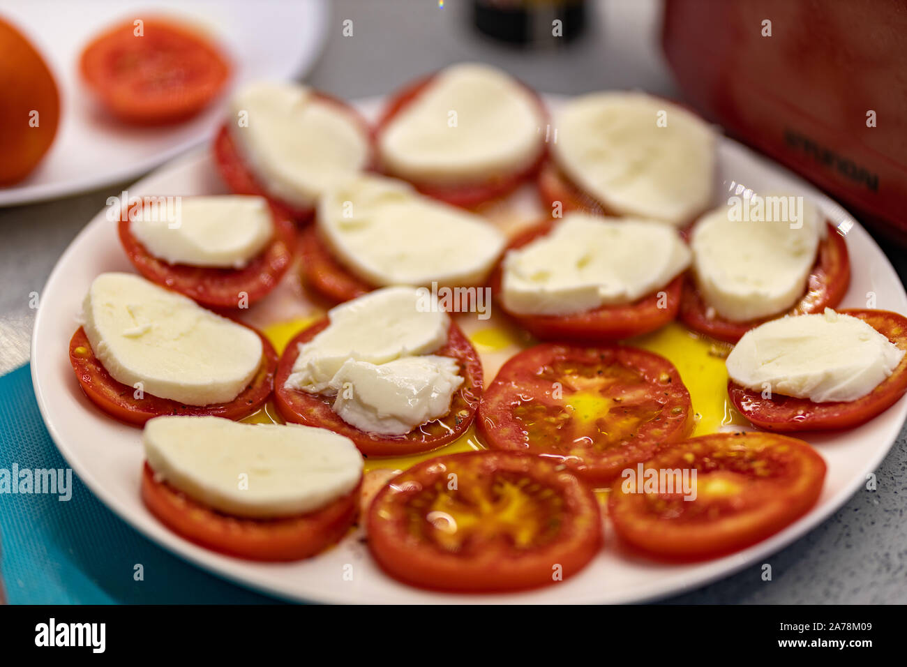 Macro shooting plate with tomatoes cheese and olive oil on the dining ...