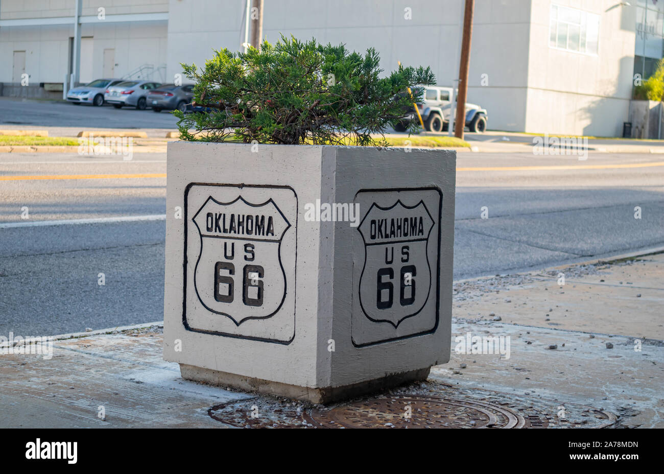 Tulsa, Oklahoma, USA. May 13, 2019. Square concrete flower pot with the sign of historic route 66 on it. An information for the drivers about the moth Stock Photo