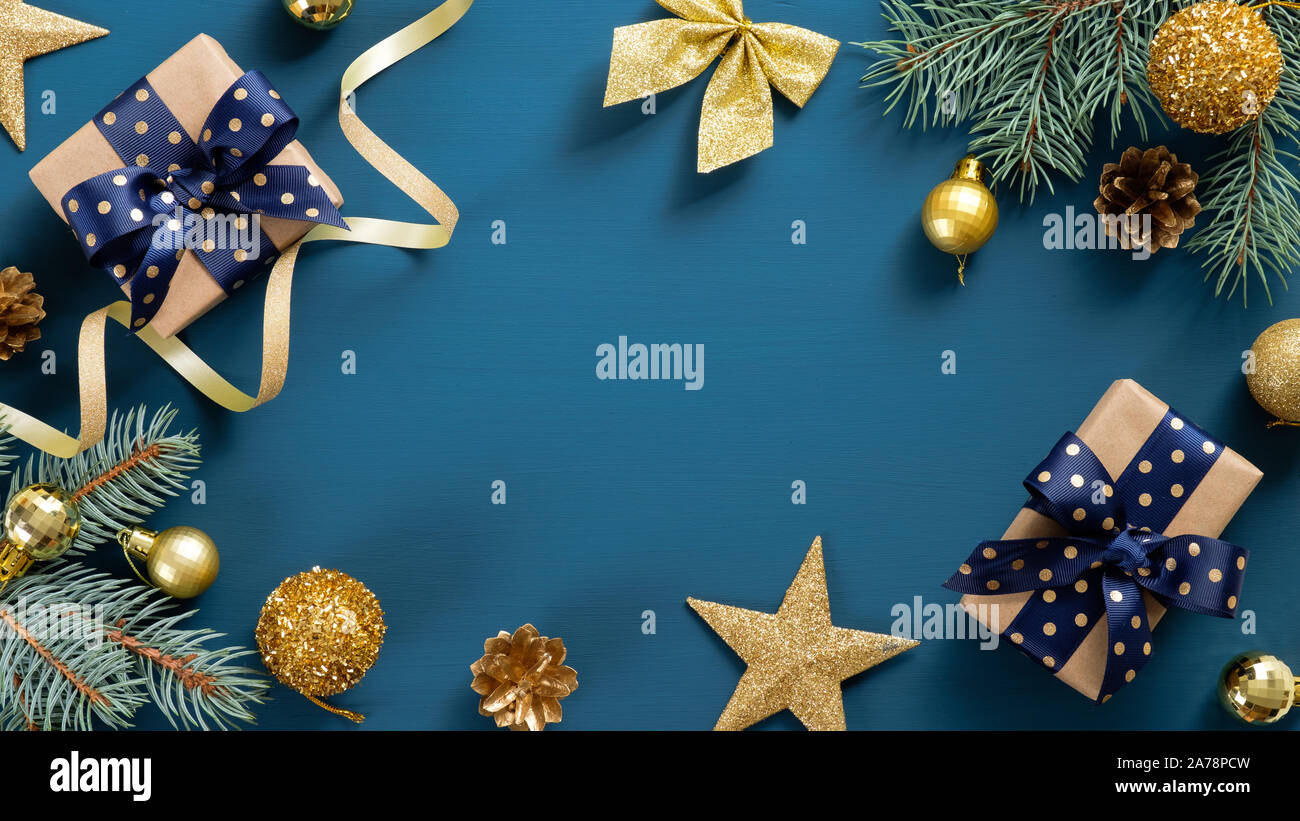 Christmas border frame of fir tree branches and golden decorations ...
