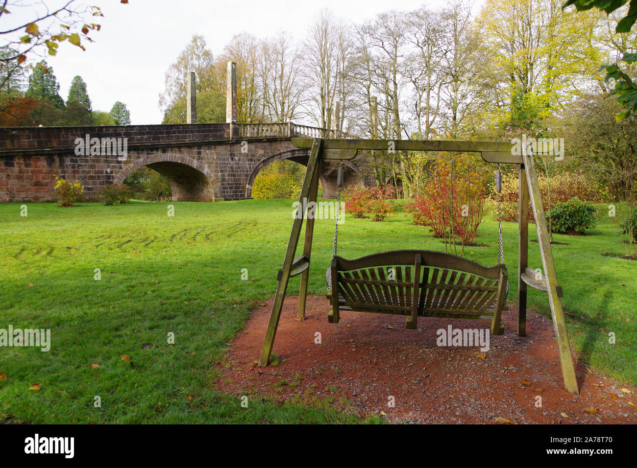Relaxing swing seat beside the Avenue Bridge in the grounds of Dumfries House in Ayrshire Stock Photo