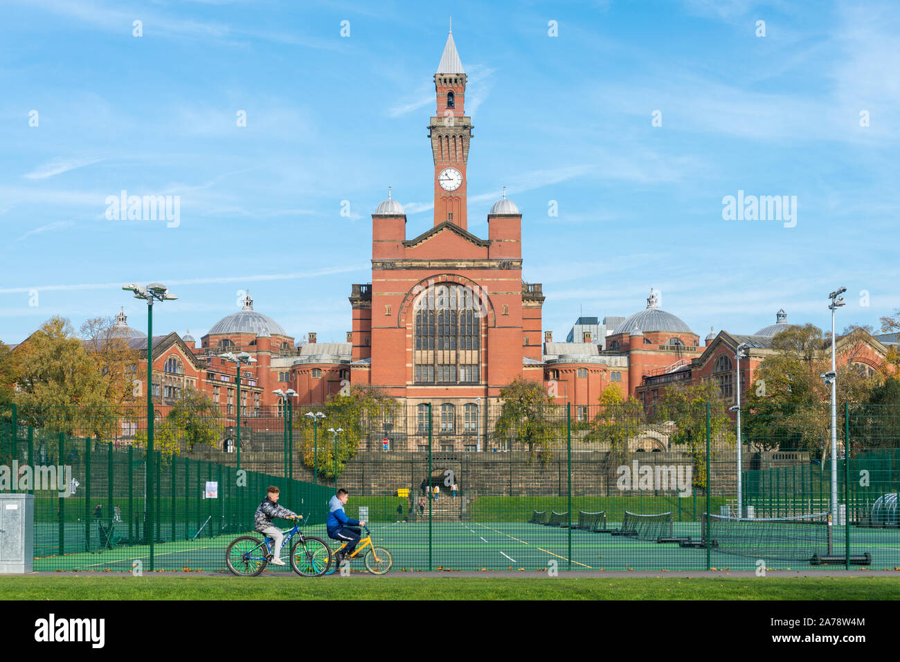 University of Birmingham all weather sports pitches with the Aston Webb Great Hall and Old Joe clock tower in the background Stock Photo