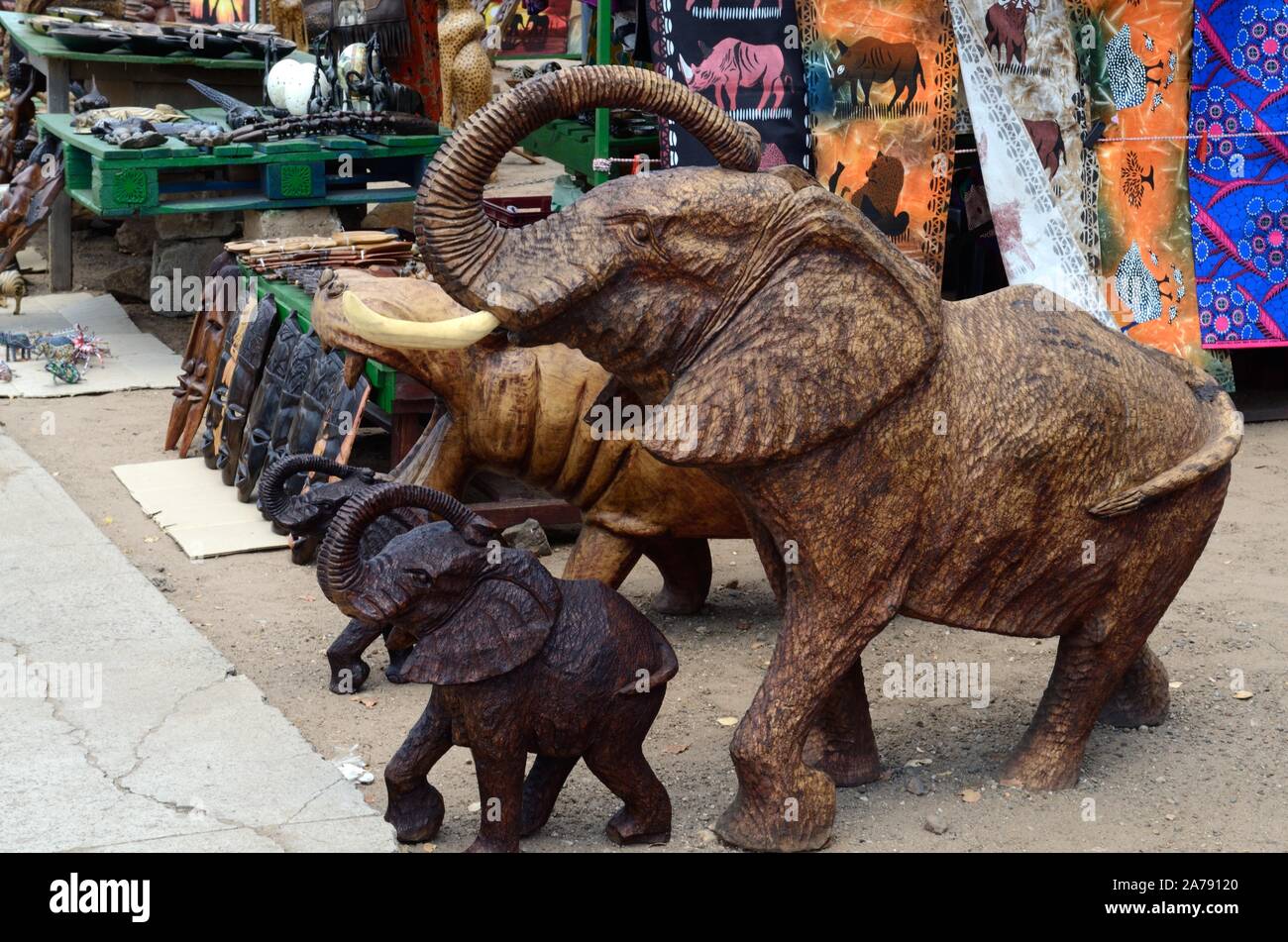 Carved wooden elephants and art craft for sale at a roadside market Botswana Africa Stock Photo