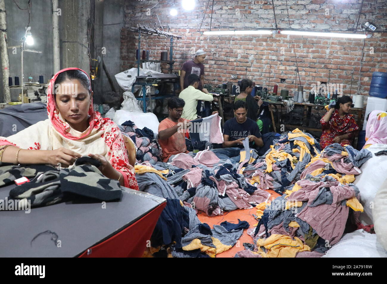 GARMENT FACTORY. Women workers sewing fabric squares
