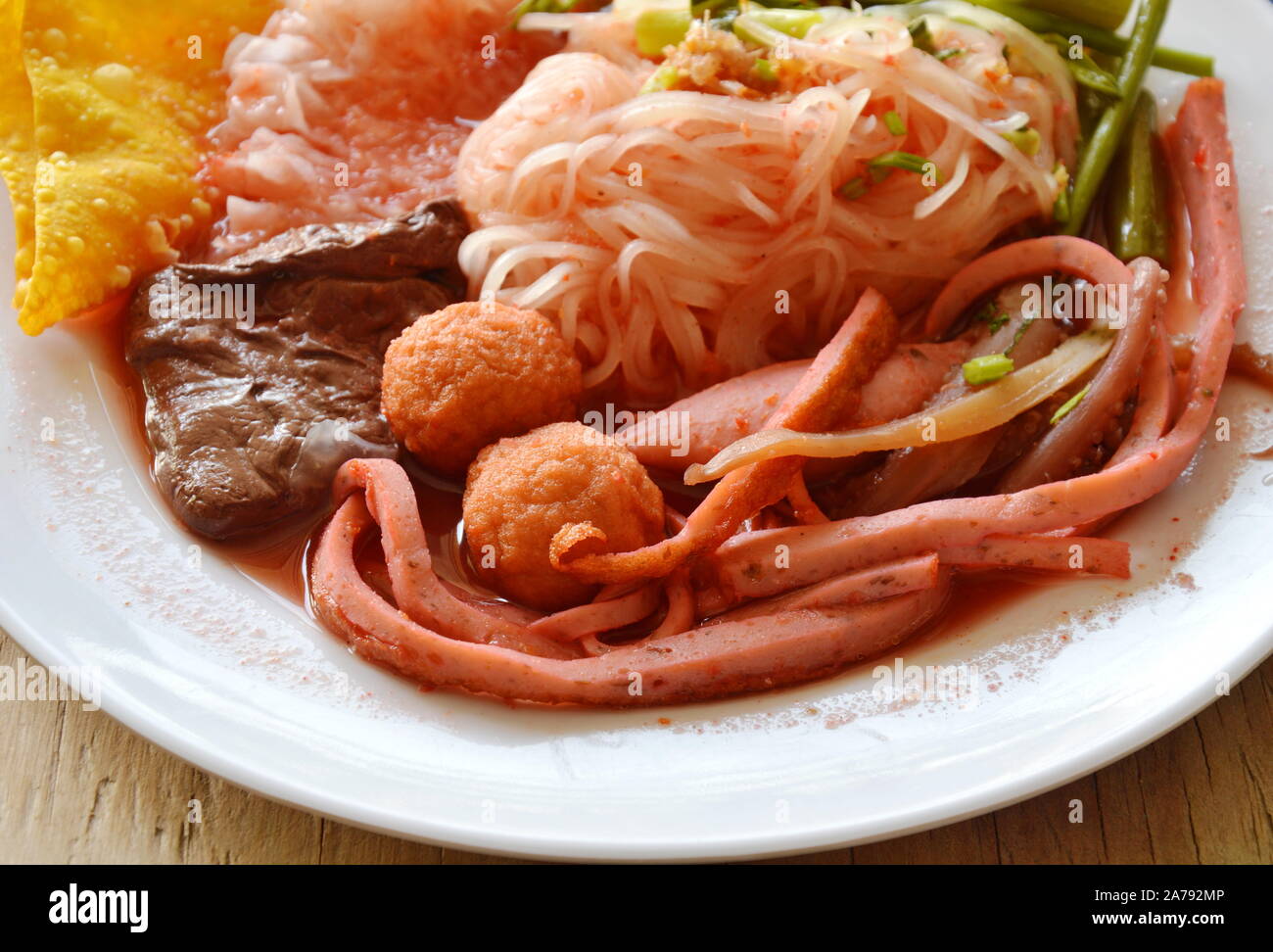 thin rice noodle with shrimp ball dressing red sauce and cayenne pepper