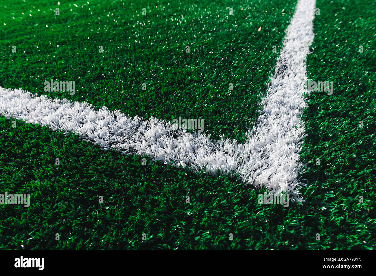 Green football field closeup. White marking line on a soccer field. New