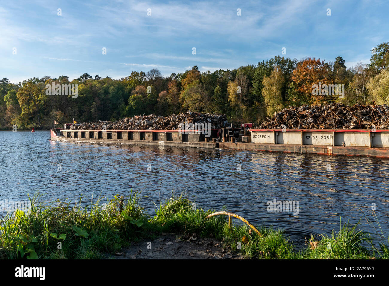 barge with scrap metal for recycling on Teltow canal, Machnow lake, Berlin Brandenburg Stock Photo