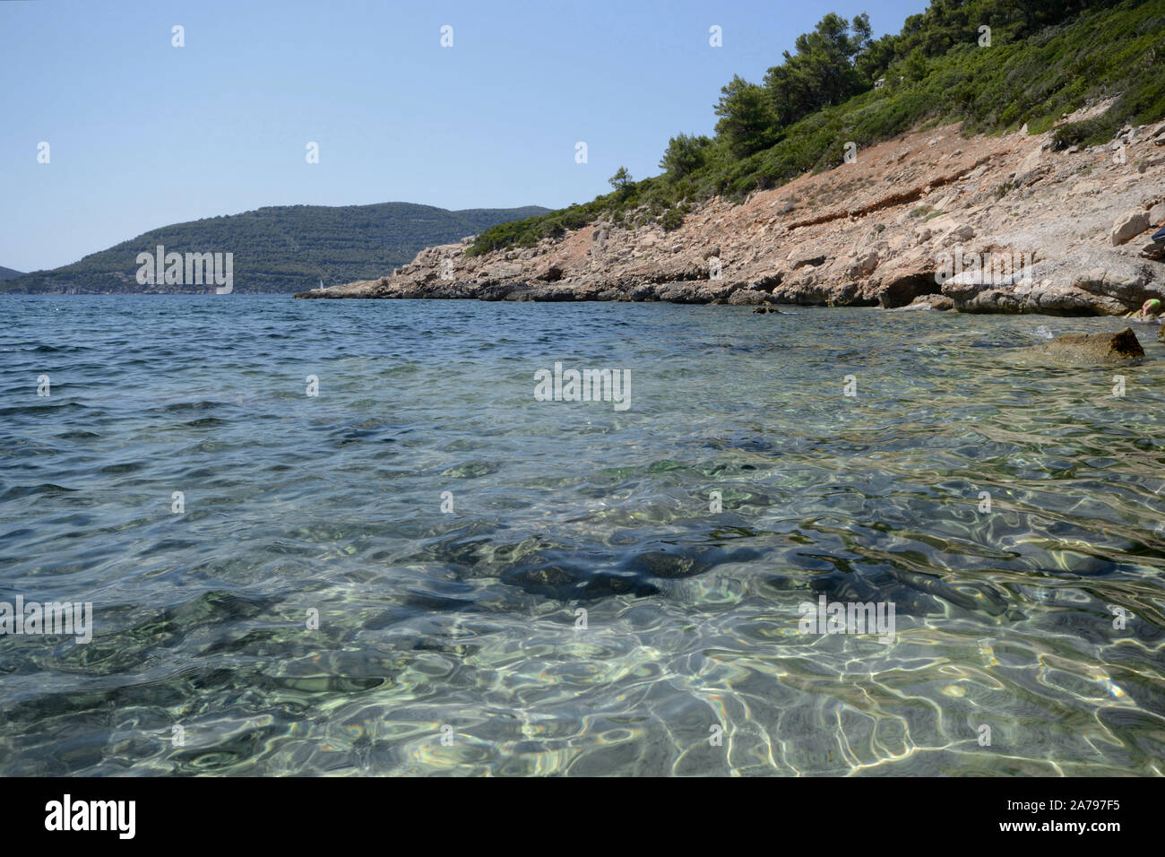 sea and rocks in Punta Giglio promontory of Porto Conte Natural Park in Sardinia on a sunny day Stock Photo